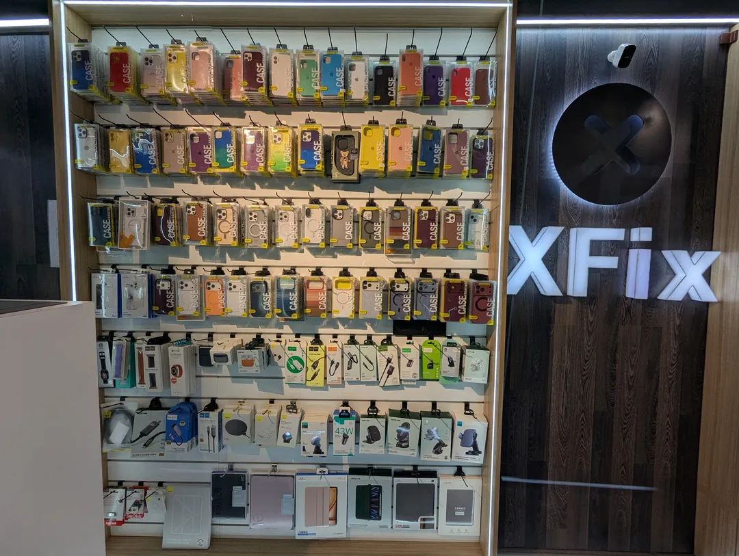 The accessories wall at XFix: phone cases, Apple Watch bands, cables, chargers and car holders