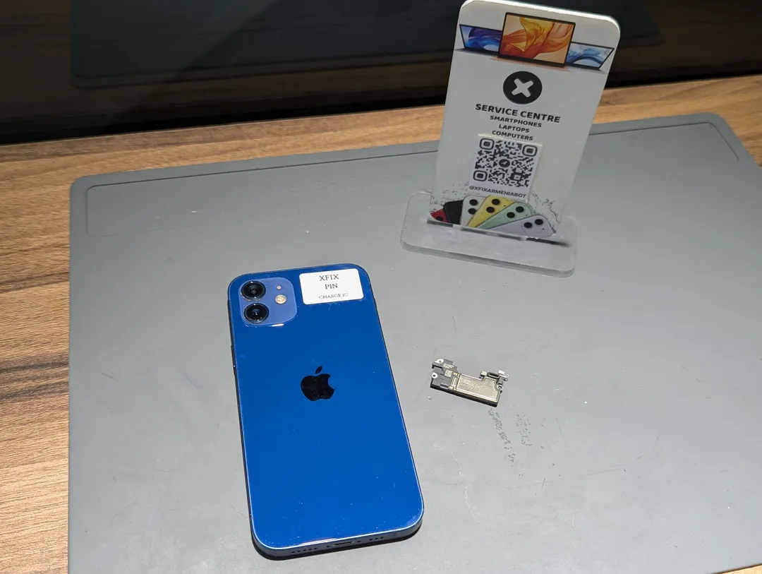 iPhone 12 next to its removed speaker and the XFix stand
