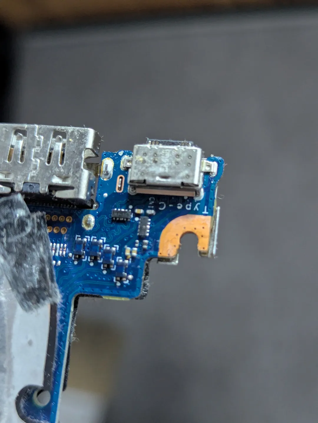 Laptop USB-C charging port board, taken out of the laptop