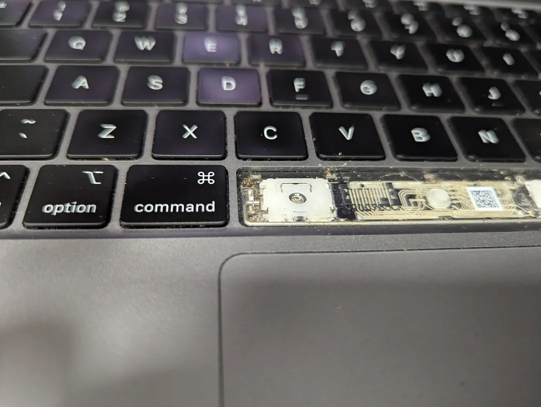 MacBook keyboard with a key taken off, showing the key mechanism