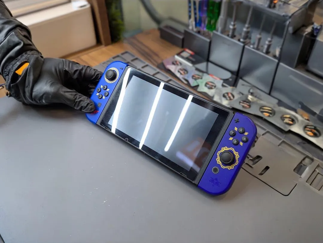 Nintendo Switch with lines across the screen, on an anti-static mat