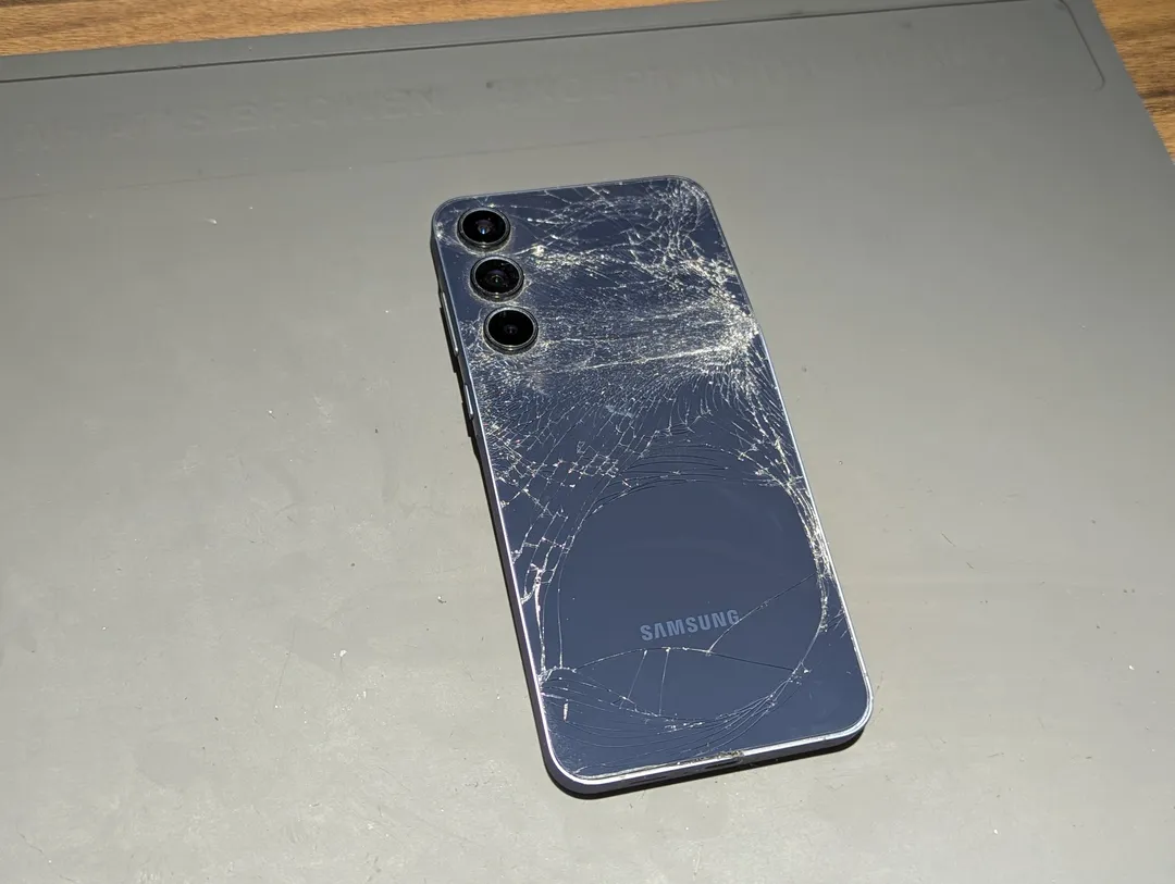 Samsung Galaxy with shattered back glass, on an anti-static mat